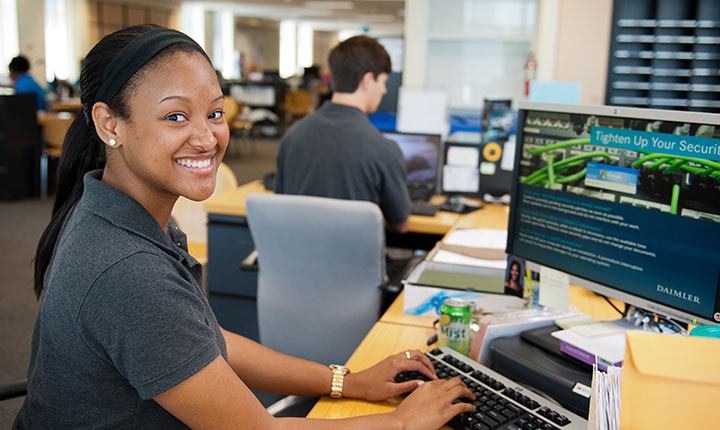 Student typing on computer